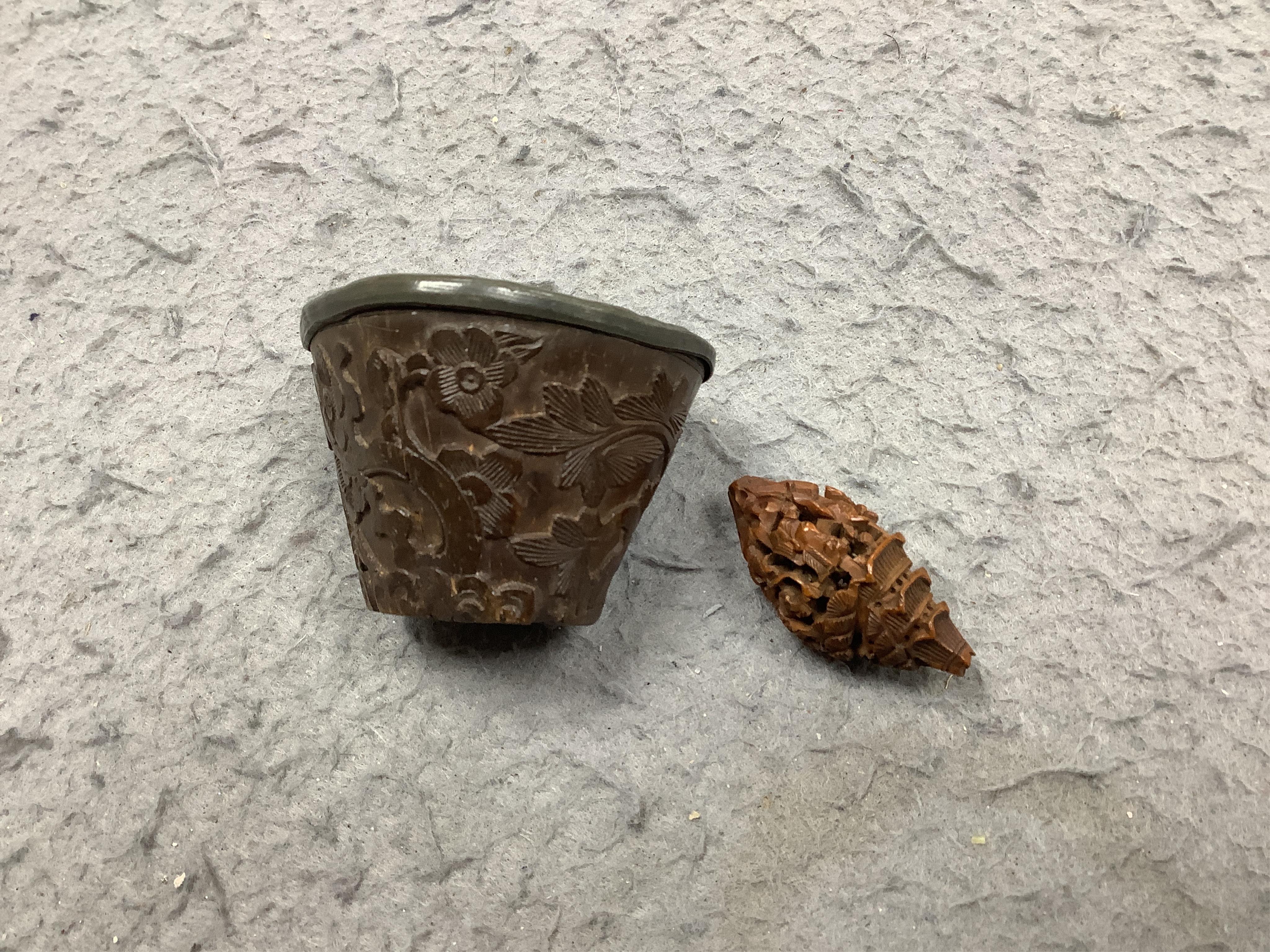 Four Chinese carved peach stones and an 18th/19th century Chinese carved wood cup, 6cm wide (5). Condition - fair to good